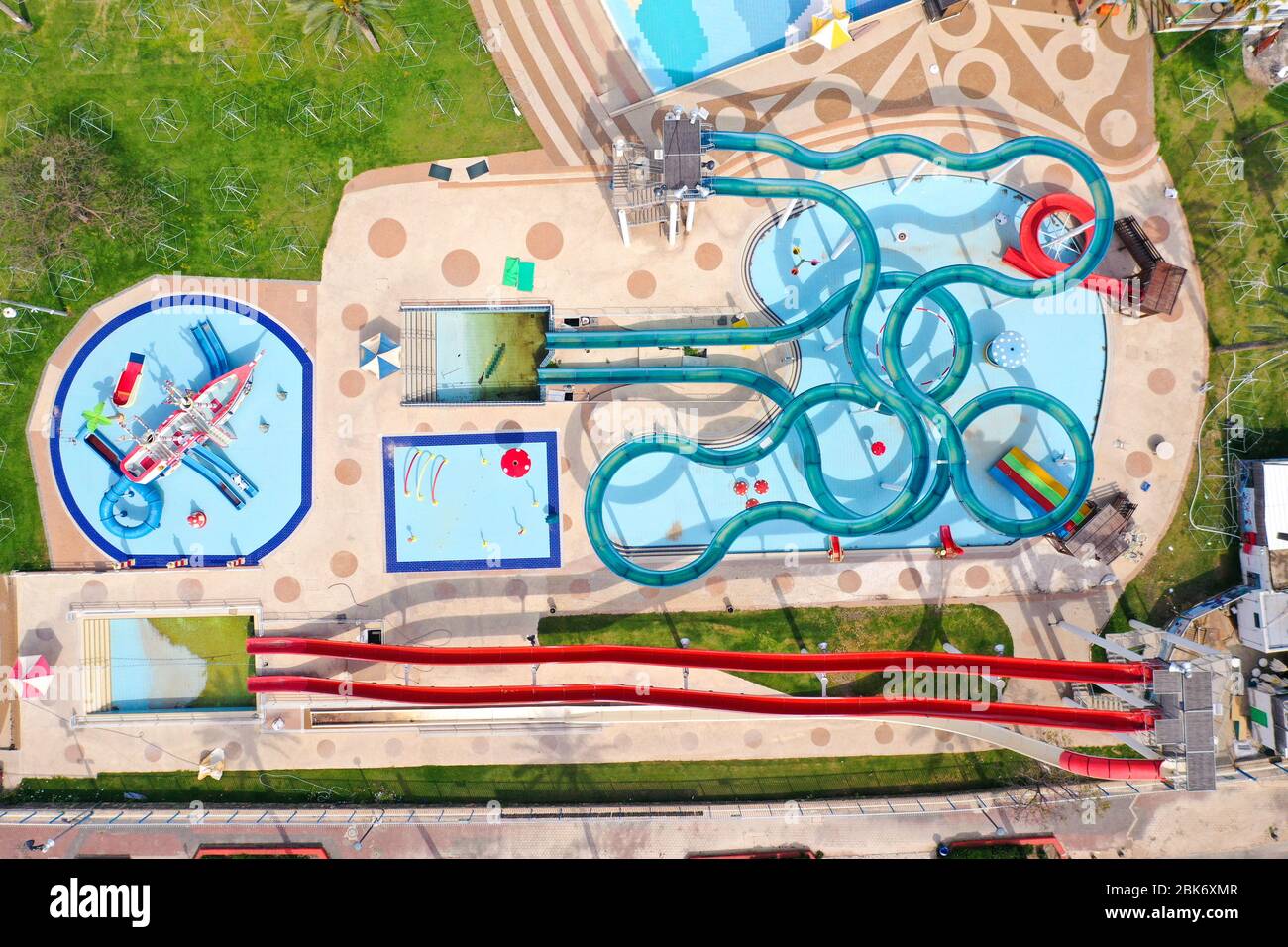 Corona Virus lockdown, Aerial image of a large and empty Water park with various Water slides and pools due to government guidelines. Stock Photo