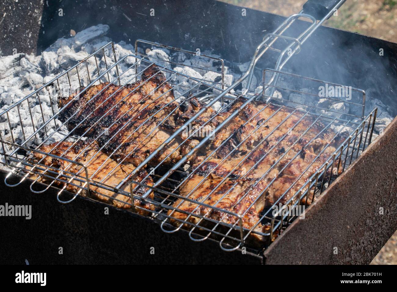 grilled meat on the charcoal grill. Embers smoke ash Stock Photo - Alamy