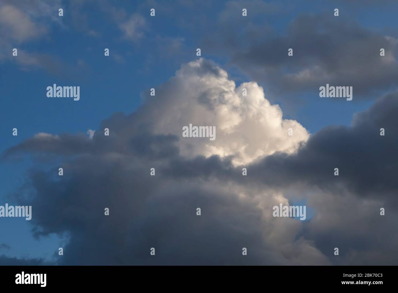 white fluffy cloud in a stormy blue sky Stock Photo