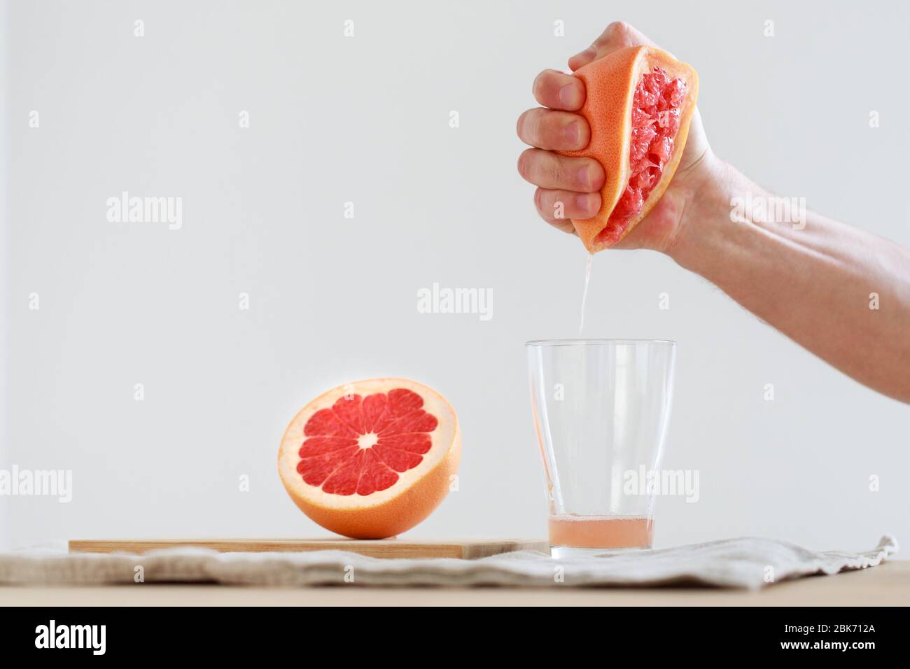 Hand squeezed grapefruit juice. Vitamin C is vital for keeping the immune system healthy. Useful for colds. Detox drink, fitness, diet. Copy space Stock Photo
