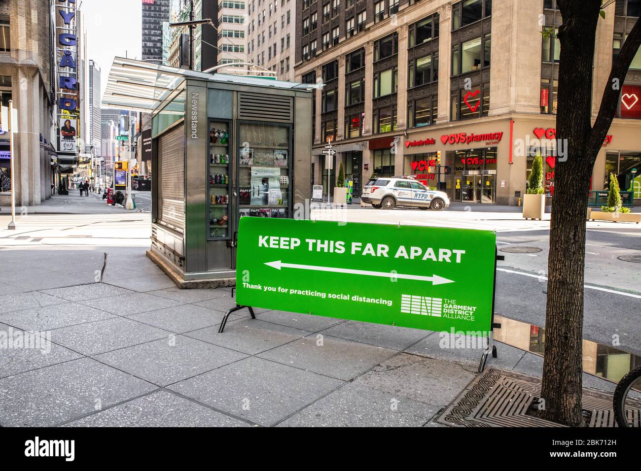 New York City, New York, USA - April 20, 2020:  View of empty street in Manhattan with sign warning to keep social distancing during the Covid-19 Coro Stock Photo