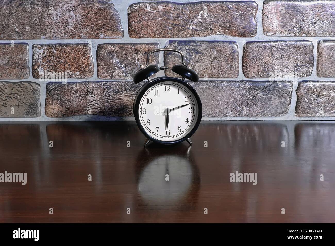 Alarm clock on the wooden table. Decoration. Vintage style Stock Photo