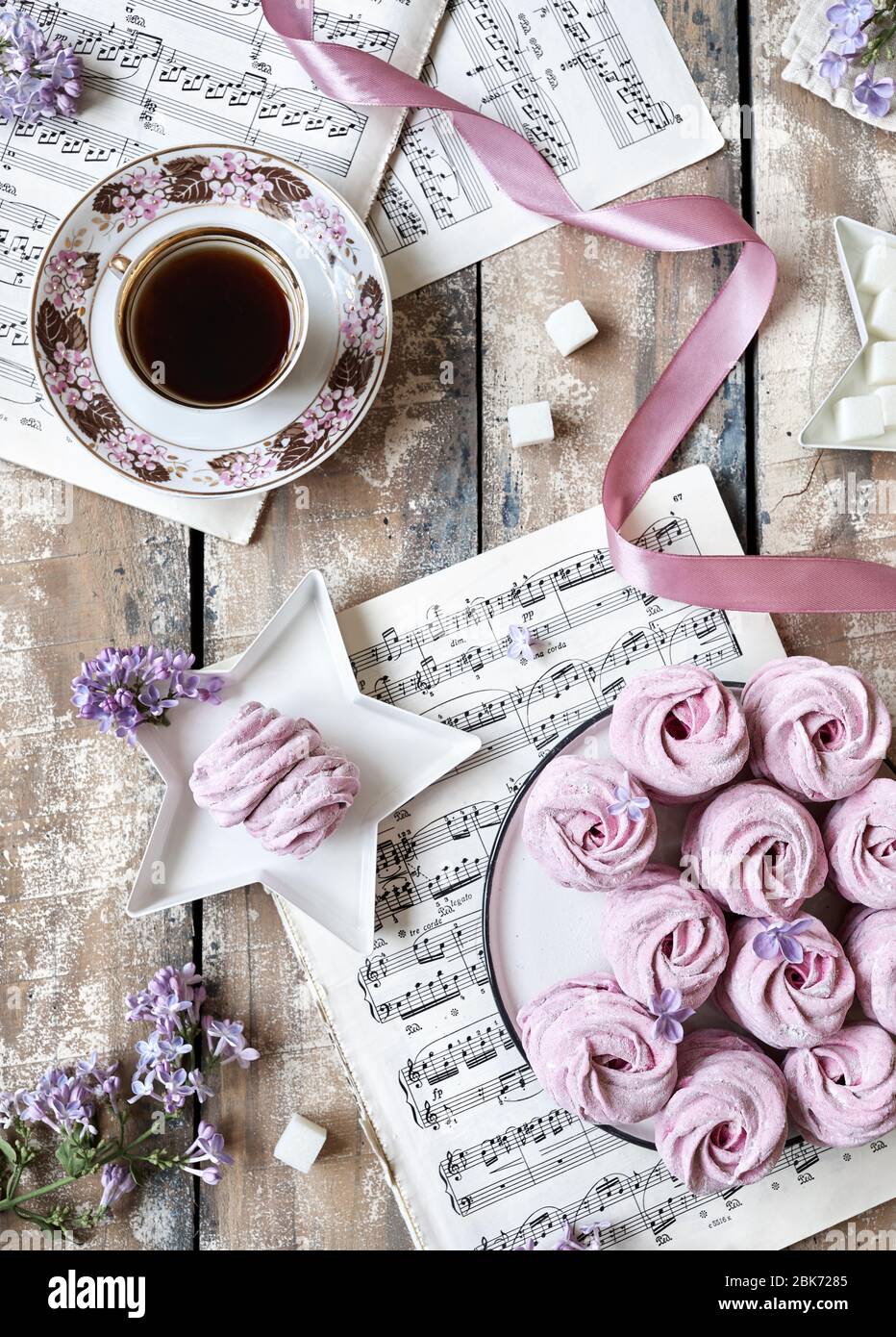 MOSCOW, RUSSIA – APRIL 3, 2020: Illustrative editorial photo with old music sheets and Violet sweet homemade Zephyr or Marshmallow from black currant Stock Photo