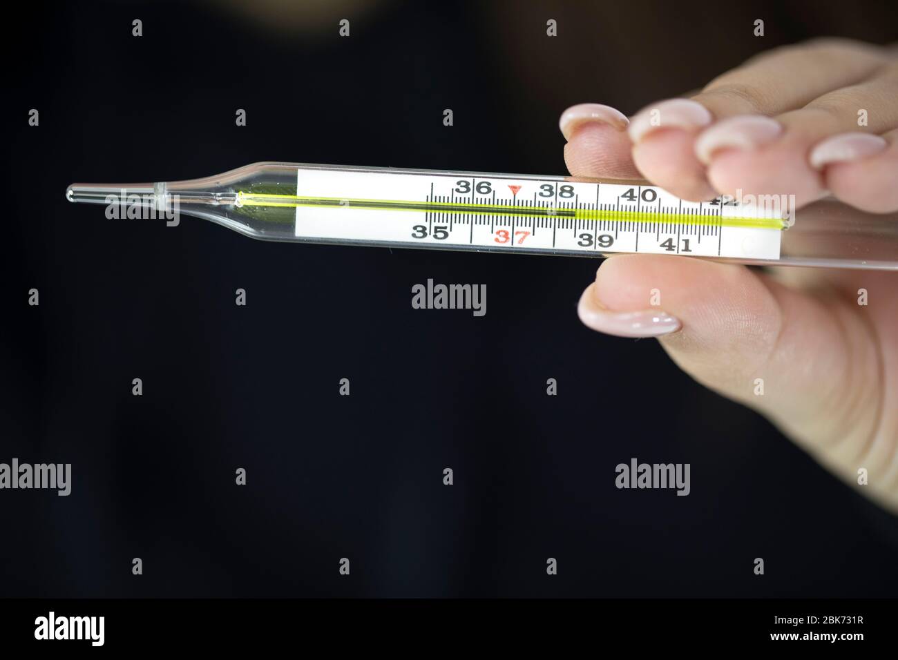 Female Holds Mercury Thermometer In Hand Which Shows 38 5 Degrees High Fever Stock Photo Alamy