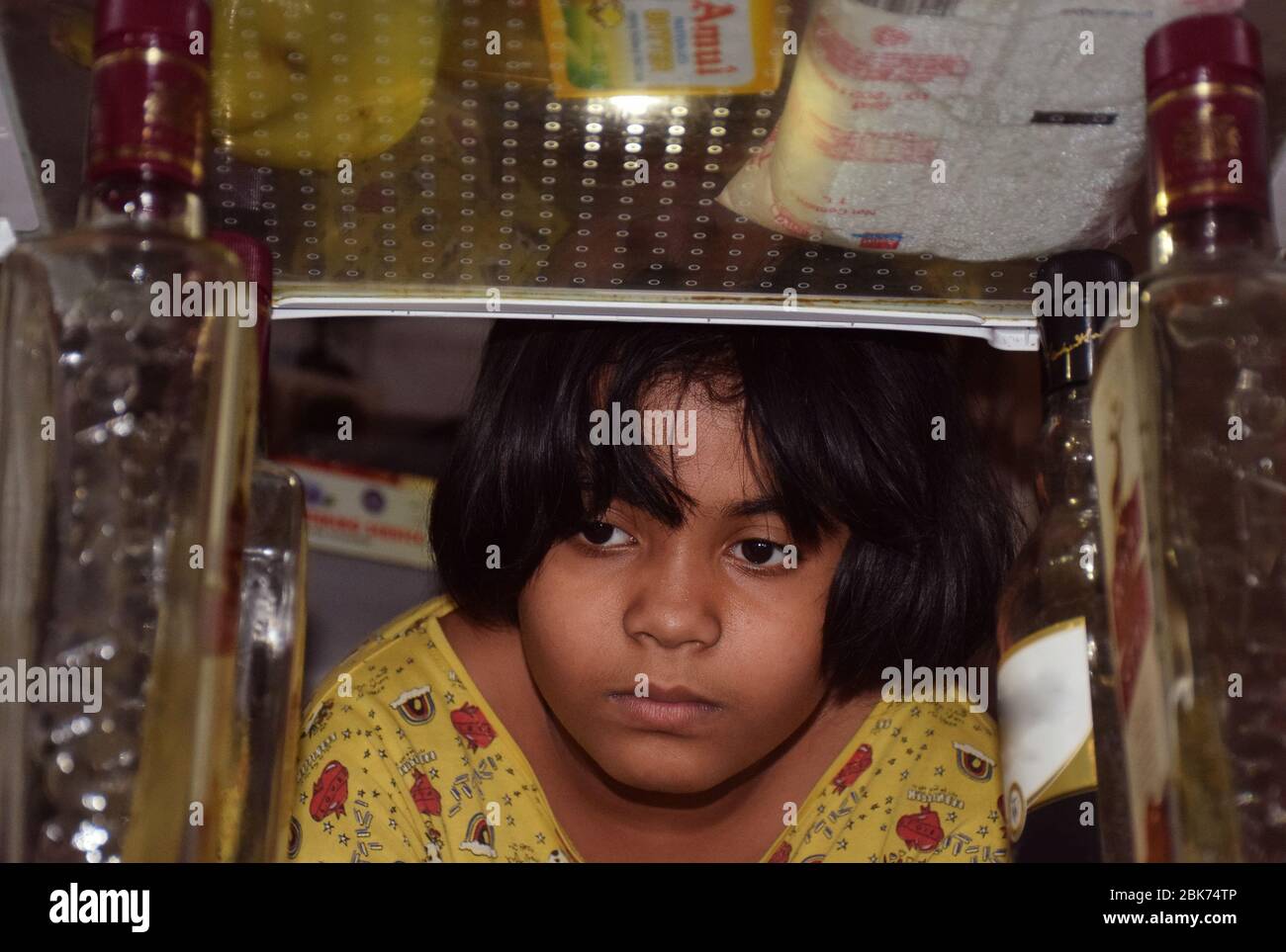 Indian girl searching something inside fridge or refrigerator Stock Photo