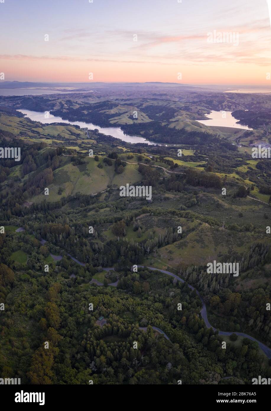 A calm sunrise greets the tranquil, green hills and reservoirs of the East Bay region of Northern California, just east of San Francisco Bay. Stock Photo