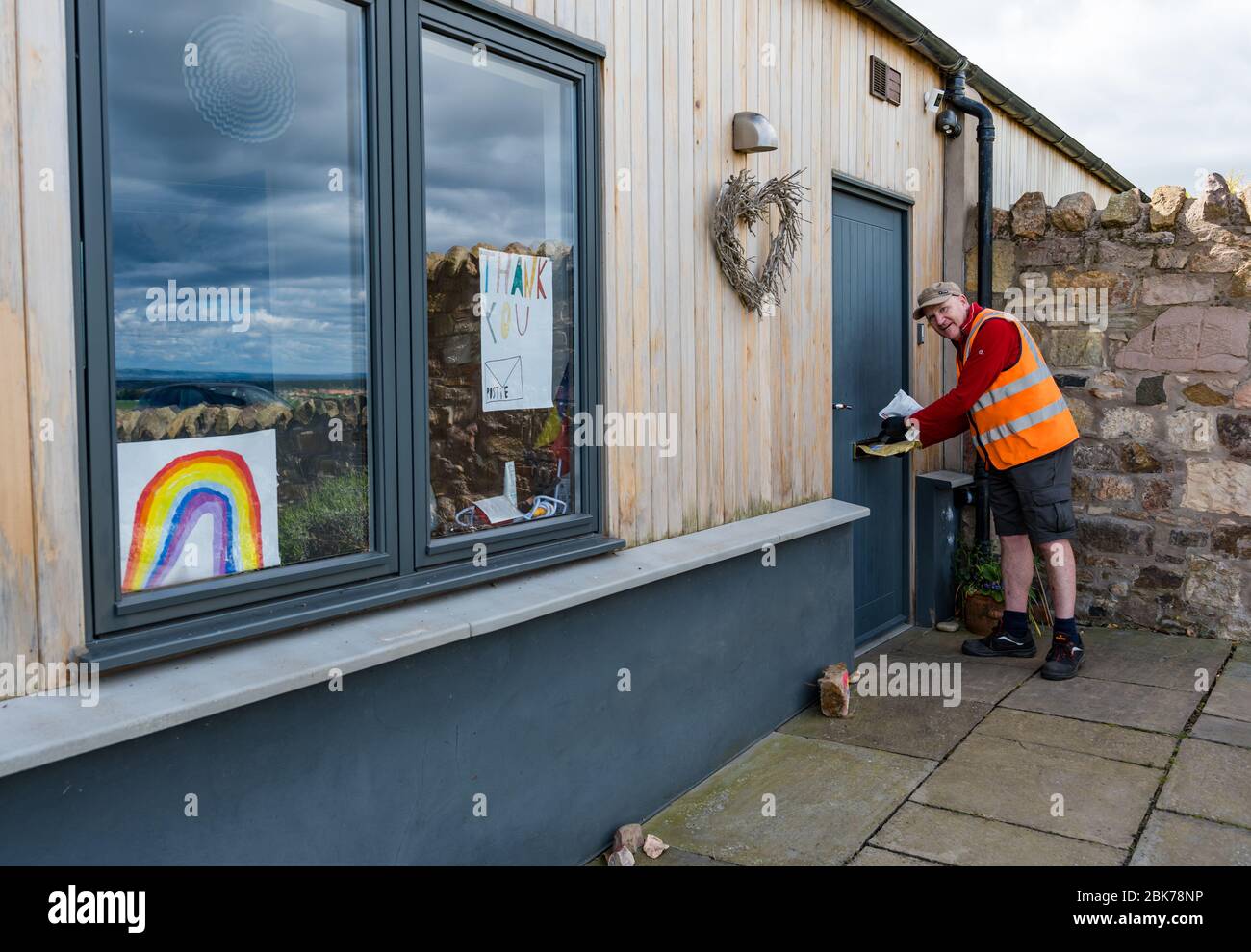 Camptoun, East Lothian, Scotland, United Kingdom. 2nd May, 2020. A community in lockdown: residents in a small rural community show what life in lockdown is like for them. Pictured: Johnstone Craig is a keyworker, the Royal Mail local postman delivering post to the community Stock Photo