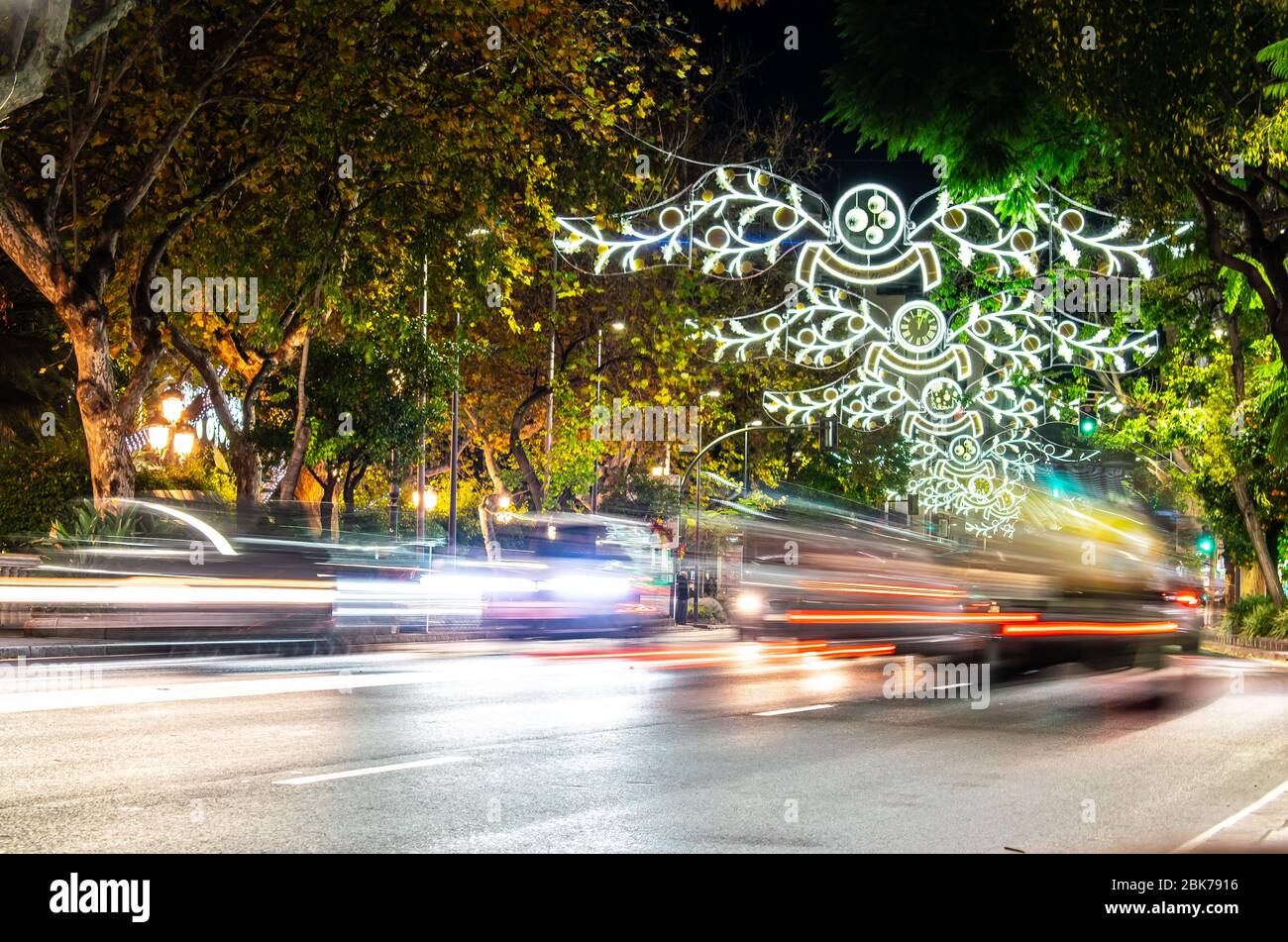 a busy night filled with lights leading up to christmas on my local high street in Marbella, Spain Stock Photo
