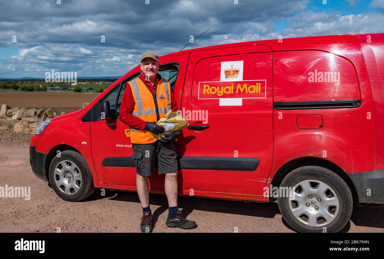 Camptoun, East Lothian, Scotland, United Kingdom. 2nd May, 2020. A community in lockdown: residents in a small rural community show what life in lockdown is like for them. Pictured: Johnstone Craig is a keyworker, the Royal Mail local postman delivering post to the community Stock Photo