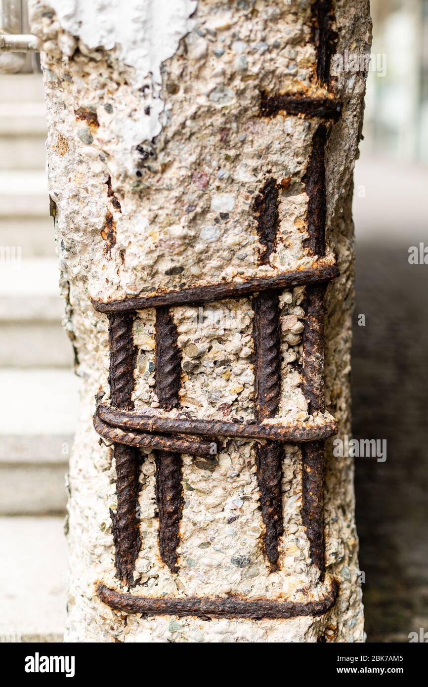 Wall and wall damage. Construction damage. Falling plaster Reinforcing bars on top. Elements for renovation. Concrete fragments. Stock Photo