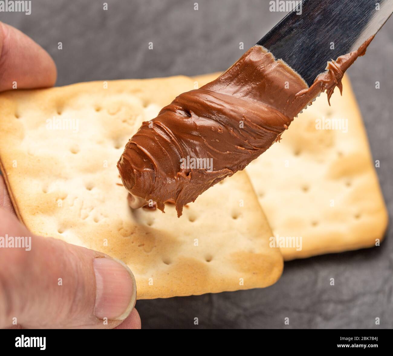 Hazelnut spread with a knife for spreading Stock Photo Alamy