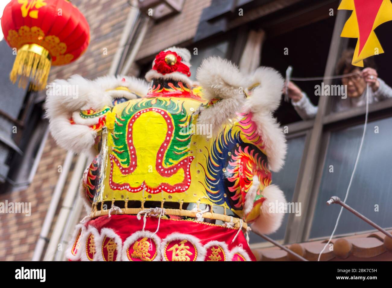 Kobe / Japan - February 17, 2018: Traditional Dragon dance during Lunar New Year celebration in Chinatown in Kobe, Japan. People trying to 'bribe' dra Stock Photo