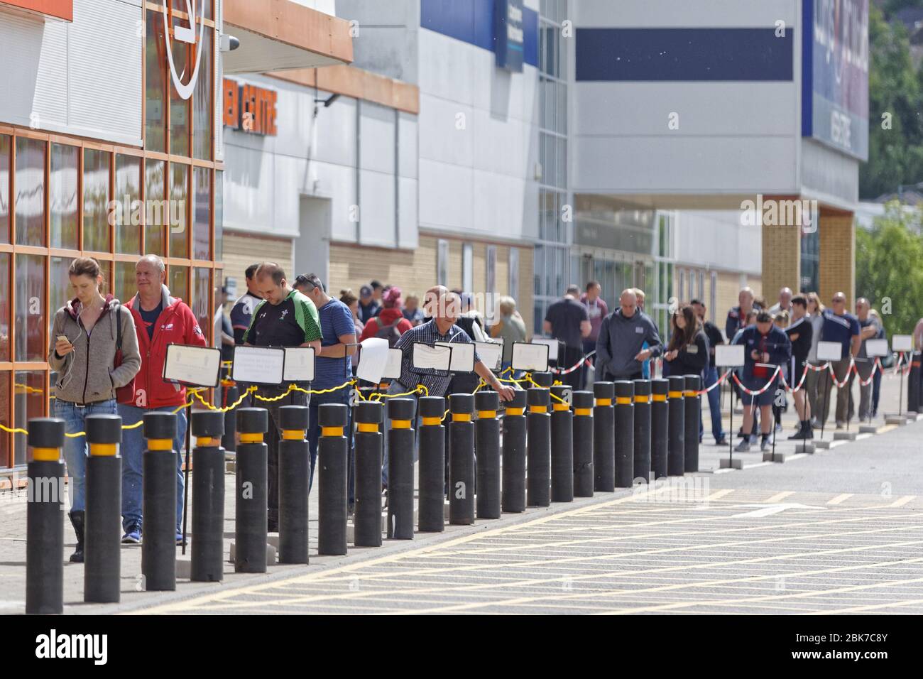 A long queue of shoppers outside the B&Q store in Swansea Stock Photo