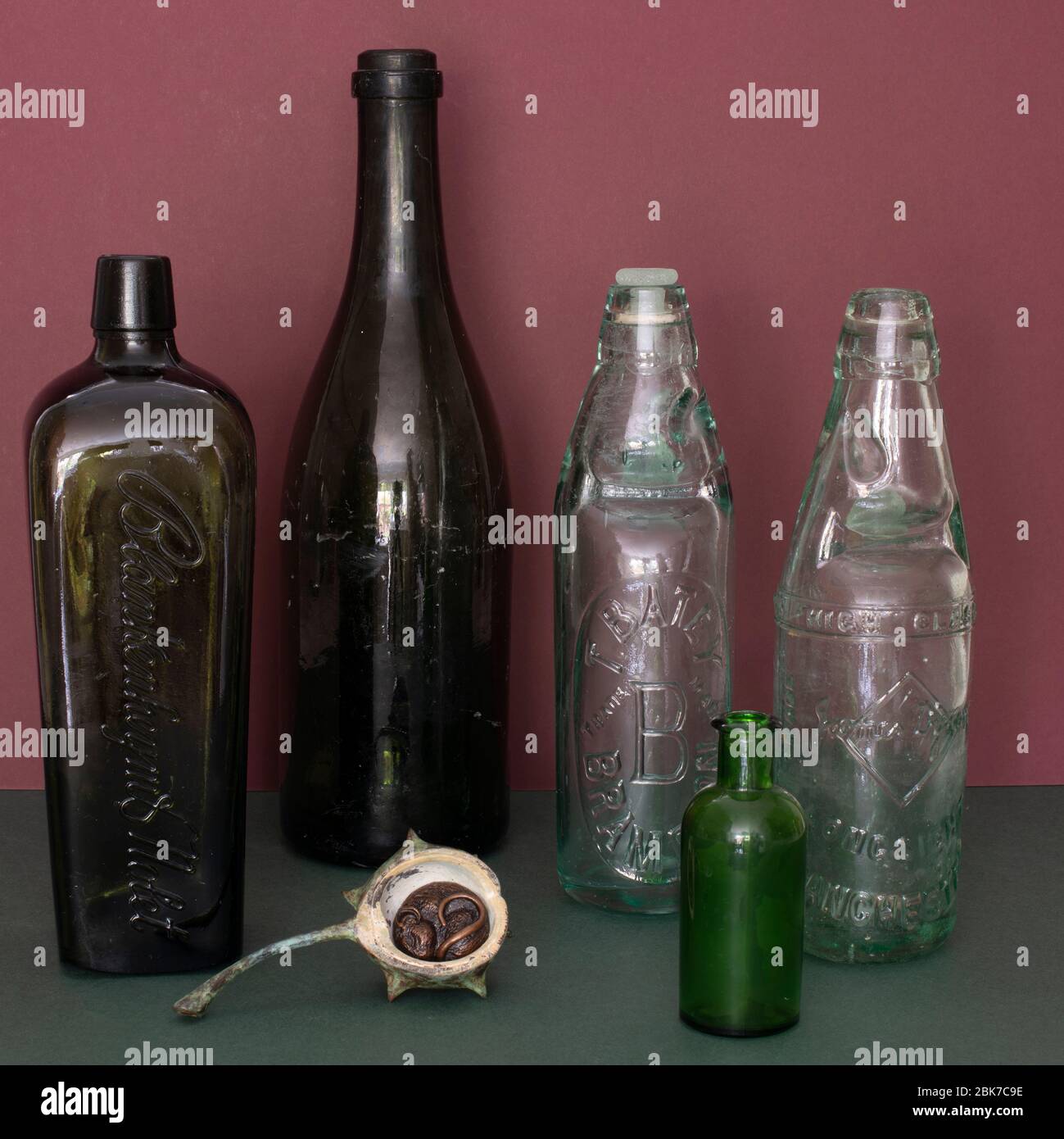 Sleeping mouse beneath empty bottles Stock Photo