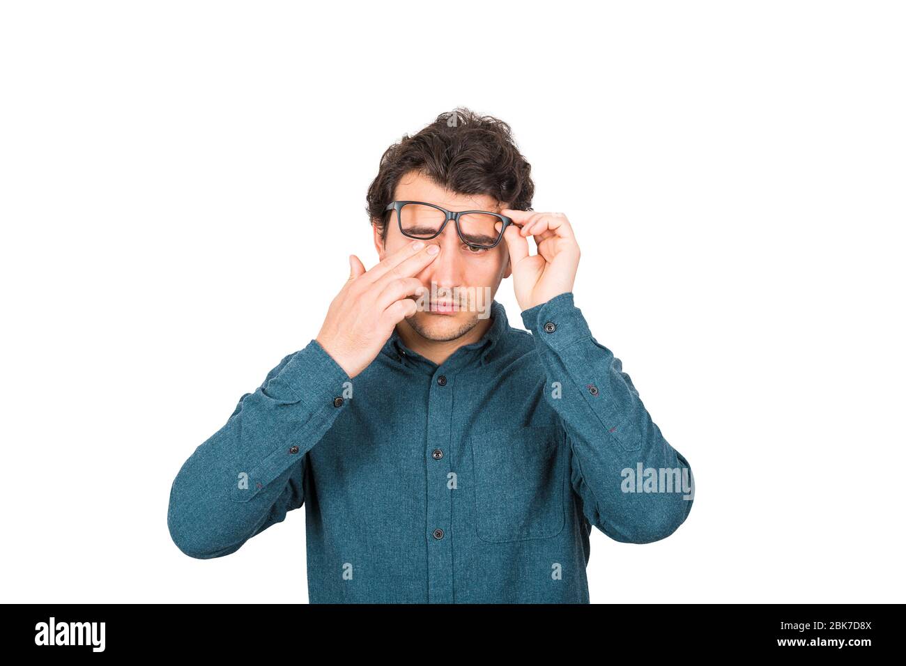 Fatigued businessman rubbing his eyes can't focus on daily work due