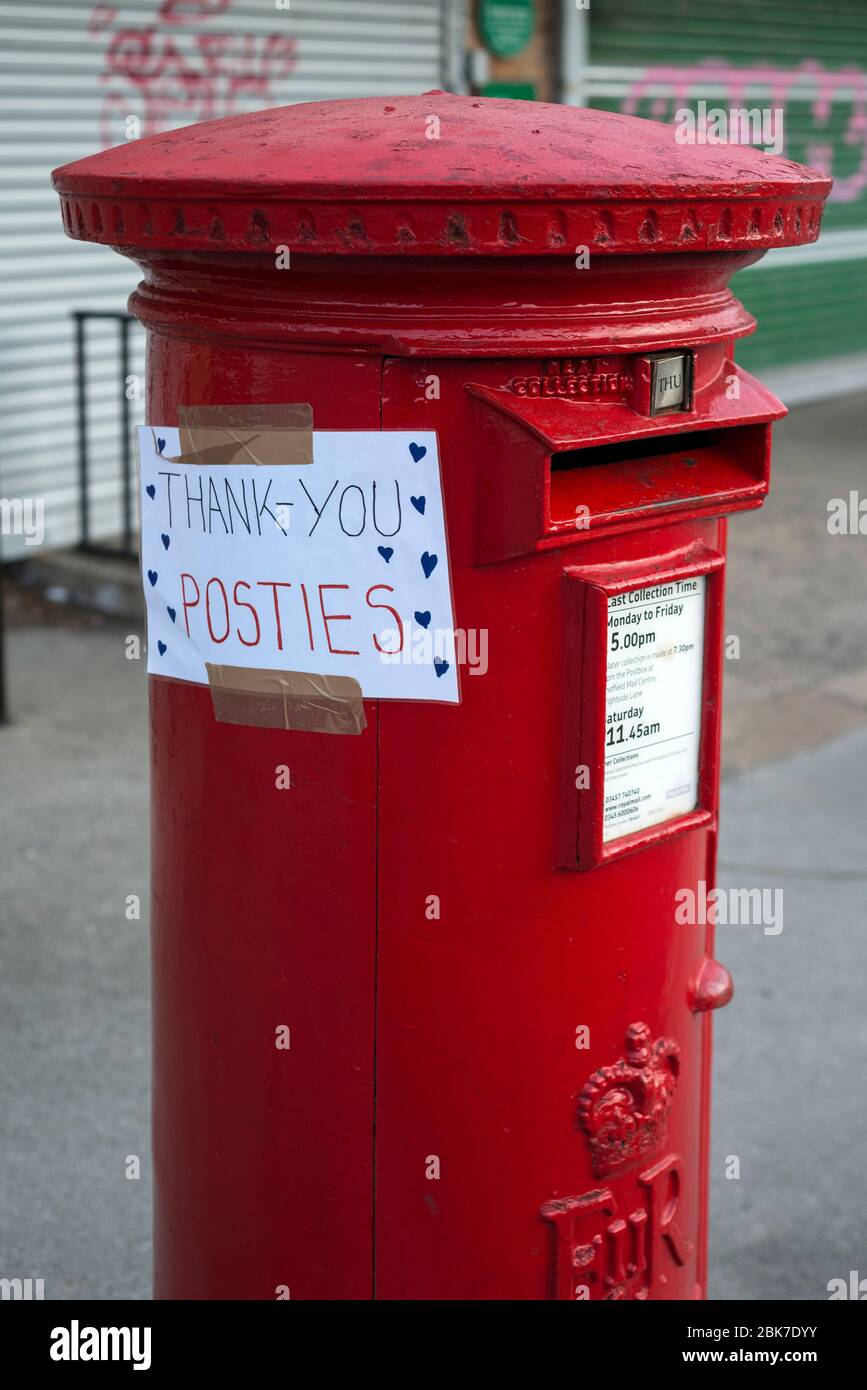 Red Post Box with 'Thank You Posties' Appreciation Sticker Stock Photo