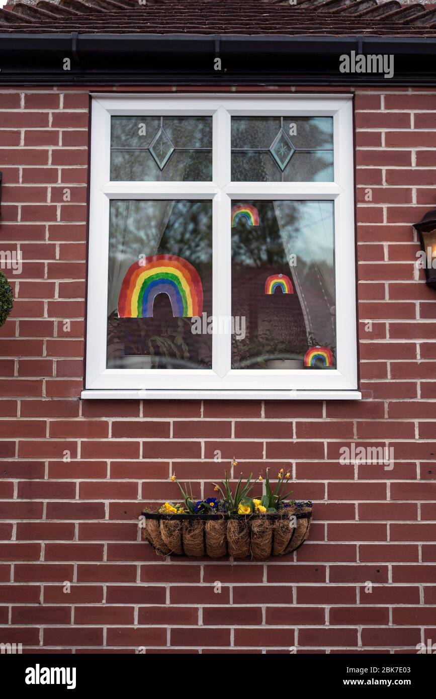 Hand-drawn Cutout Rainbows stuck on House Window Stock Photo