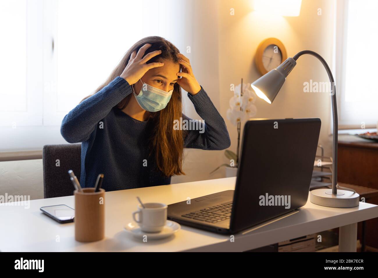 Teen student with hands on head complains of migraine with computer at ...