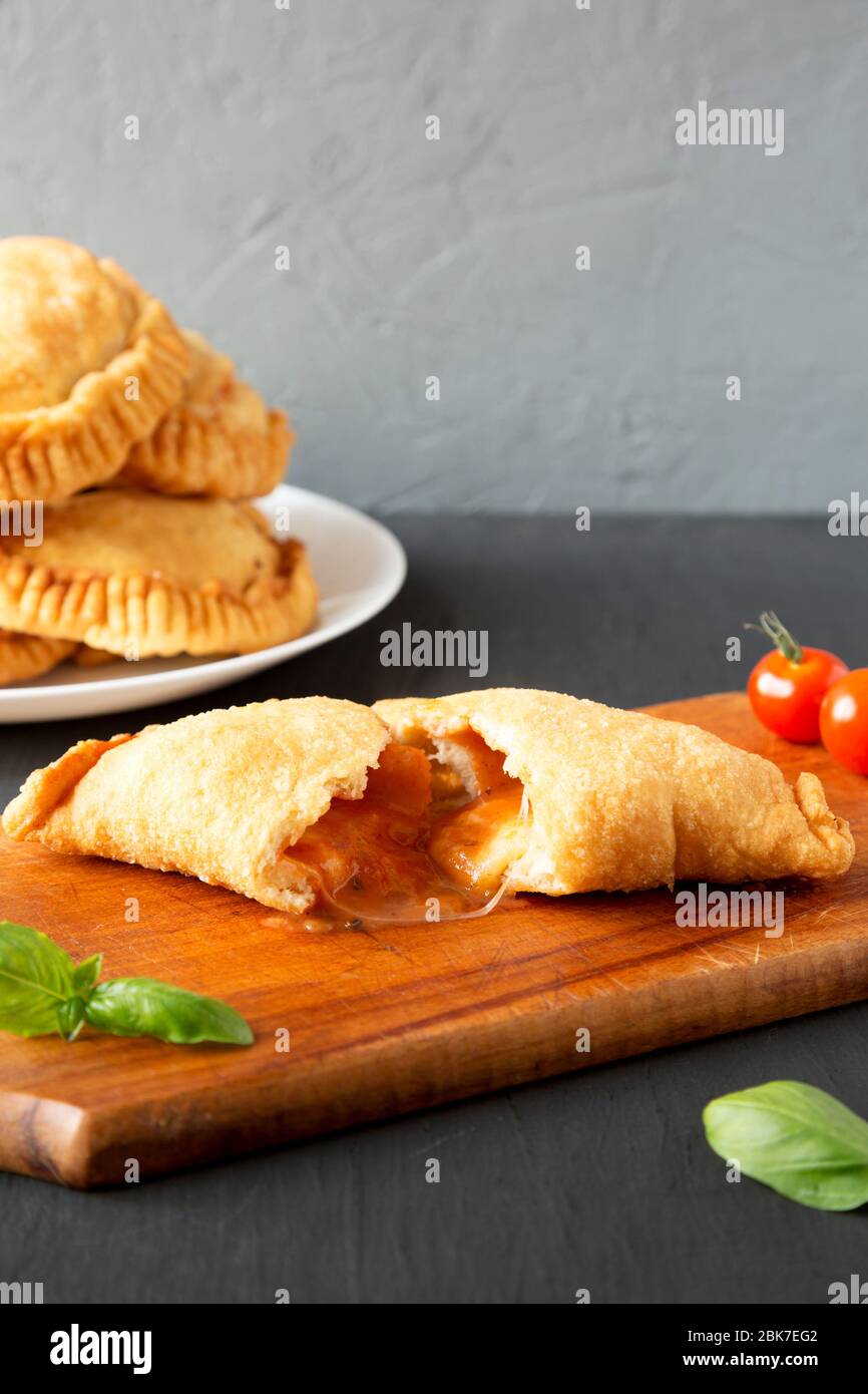 Homemade Deep Fried Italian Panzerotti Calzone with sauce, side view