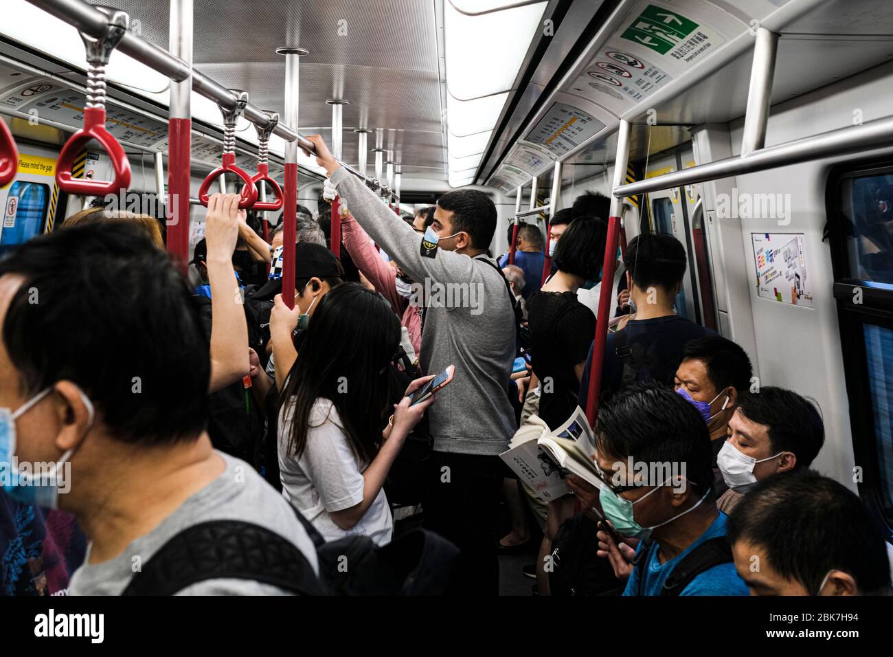 People board a tram while wearing face masks as a preventive measure during the Coronavirus (COVID-19) crisis.Hong Kong set to ease some social-distancing measures as no new Covid-19 cases for the sixth time in seven days on May 2 with the total number of infected cases remaining at 1,039. Stock Photo