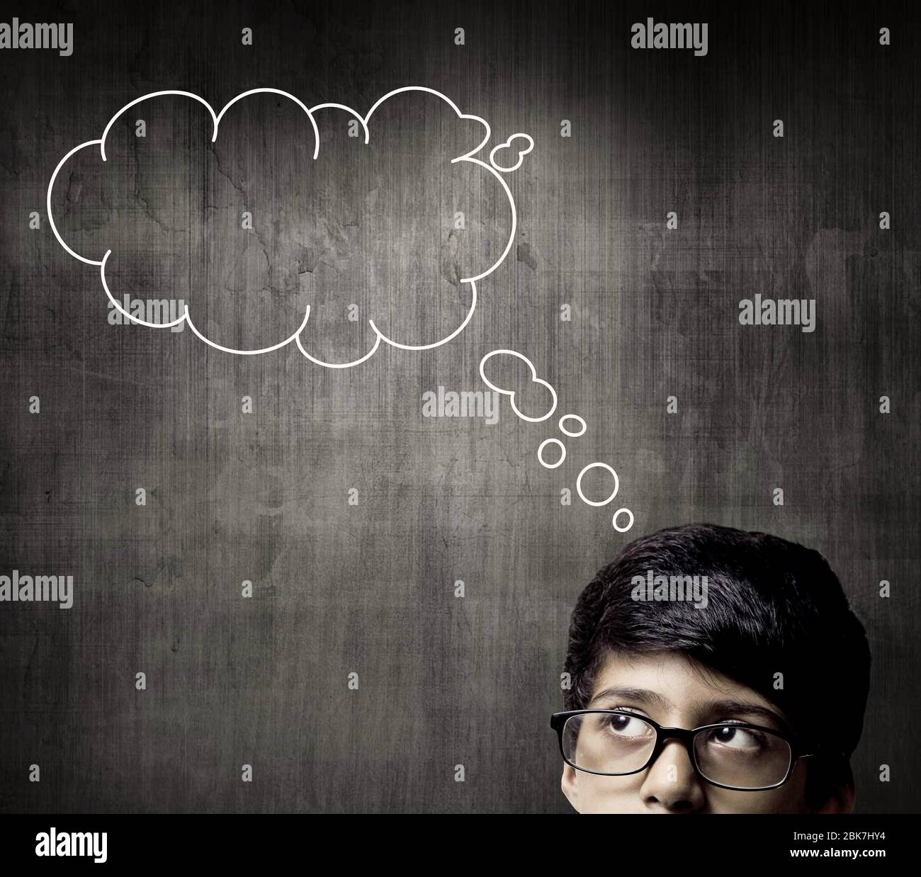 Thinking Half Head Of Genius Little Boy Wearing Glasses, Thinking Before A Chalkboard Stock Photo