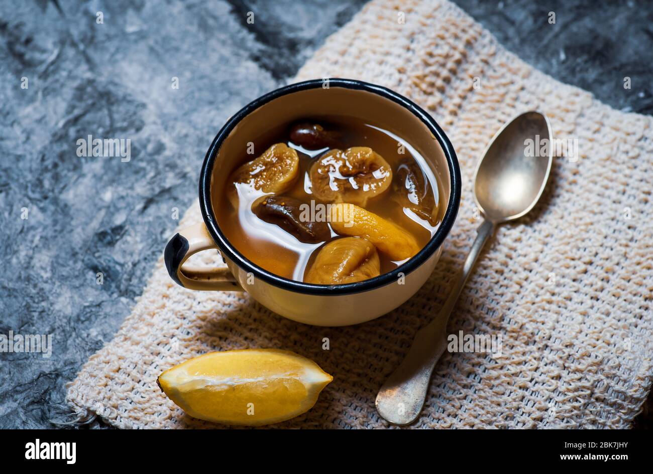Homemade compote with dried fruit mix of dates and figs with lemon in a