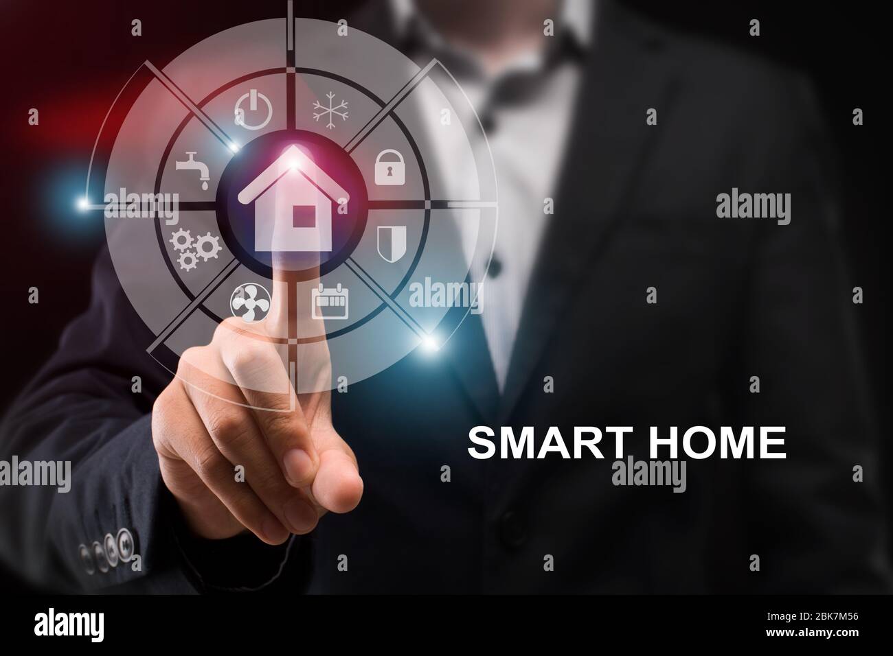 Young businessman pressing house icon on transparent display and words