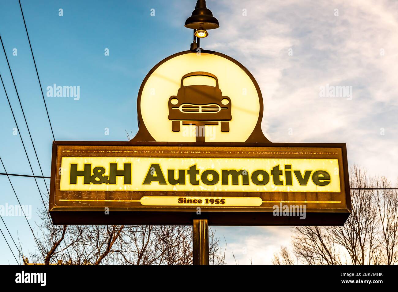 Horizontally oriented shot of distinctive vintage 'H&H Automotive' freestanding sign showing brand and logo in brown and beige. Stock Photo