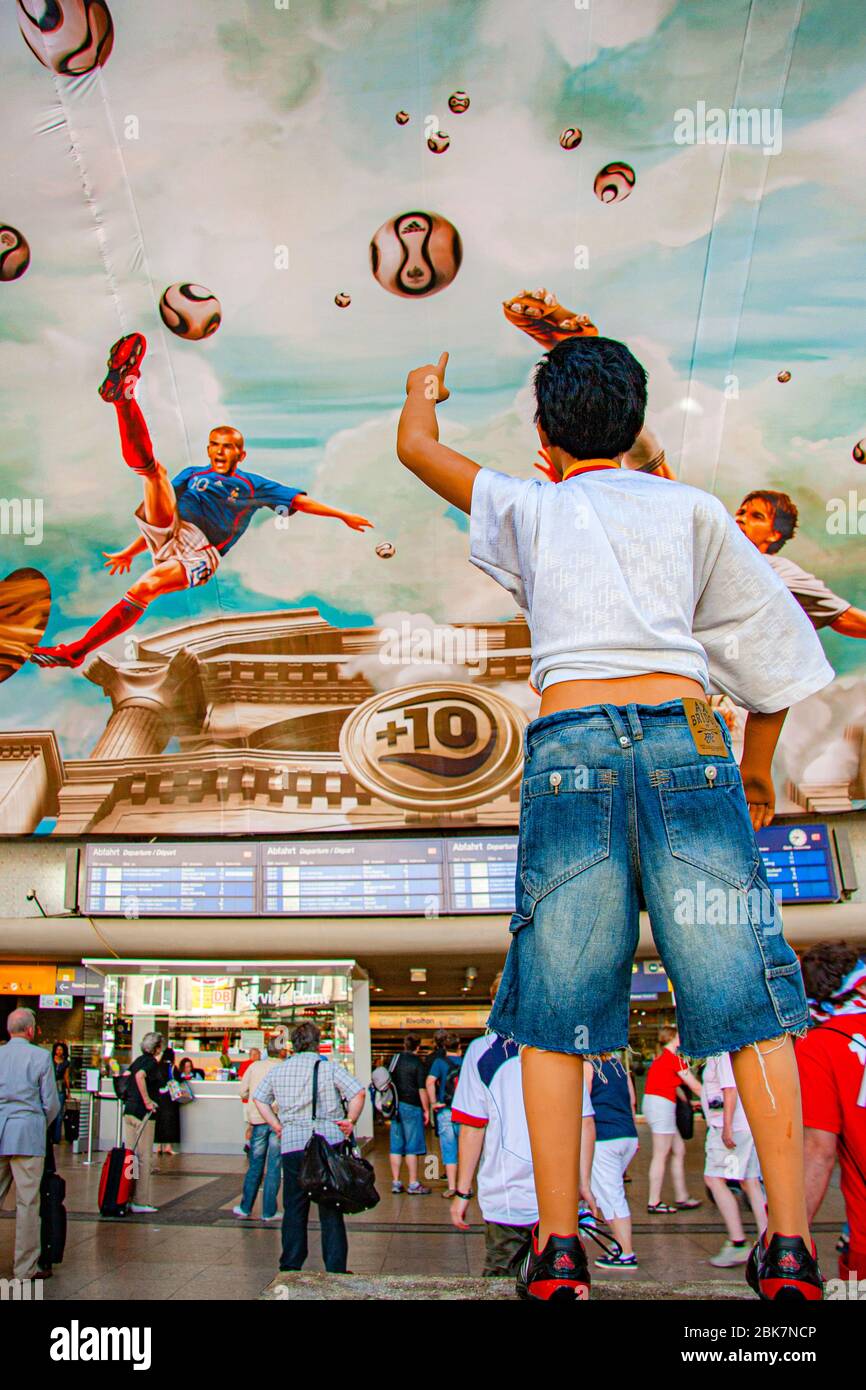 Main Train Station Ceiling Painting with Football Scenes, Köln, Germany. During 2006 FIFA World Cup. On an area of more than 800 square meters, Adidas has had a fresco installed on the ceiling of Cologne's main train station. In a true-to-the-original antique look, national players such as Michael Ballack, David Beckham, Zinédine Zidane and Juan Román Riquelme float high above the heads of passers-by Stock Photo