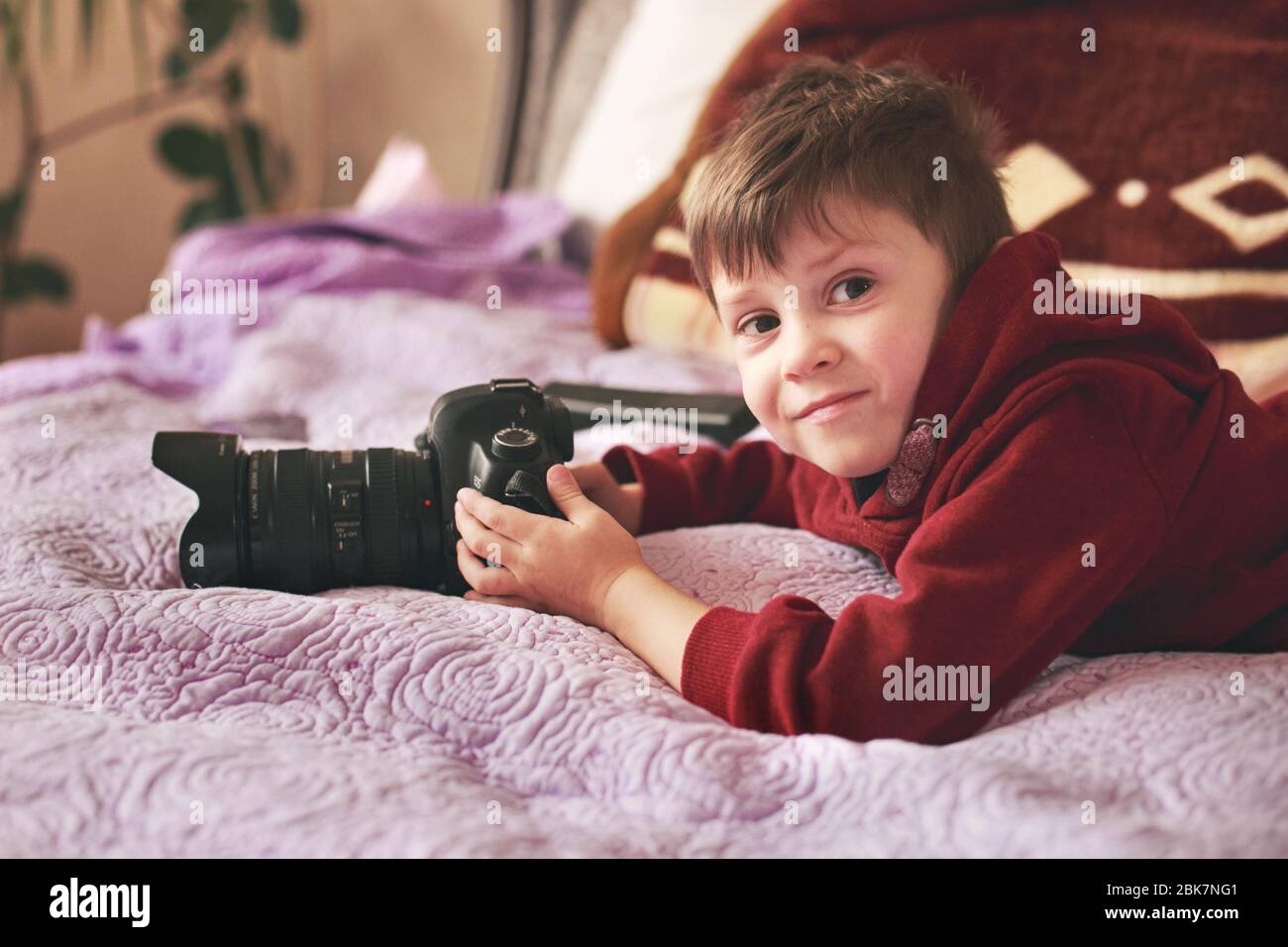 A little boy holding a professional camera, a future photographer Stock ...