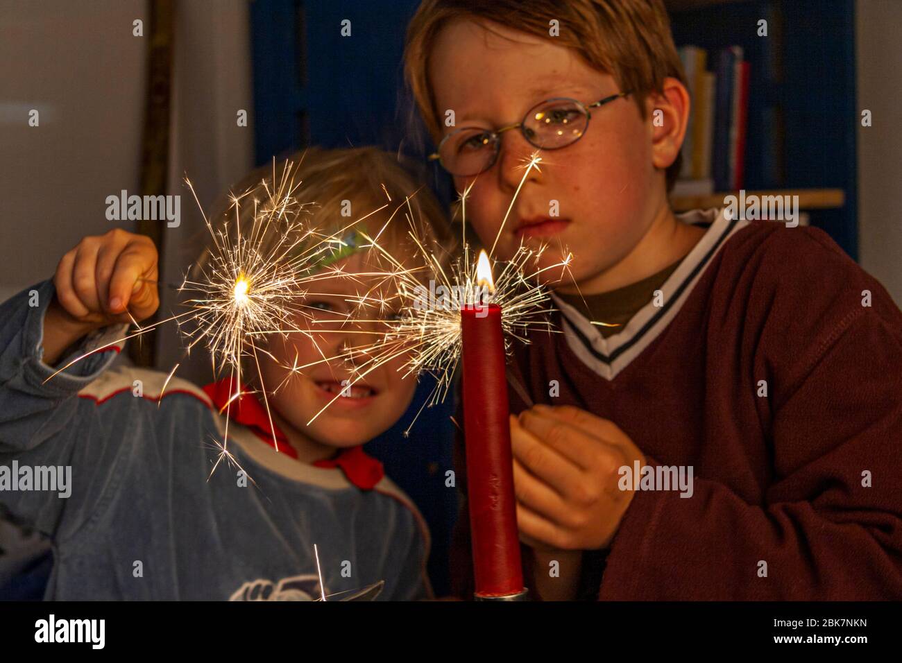 Two boys playing with candles and sparklers in Grevenbroich, Germany Stock Photo