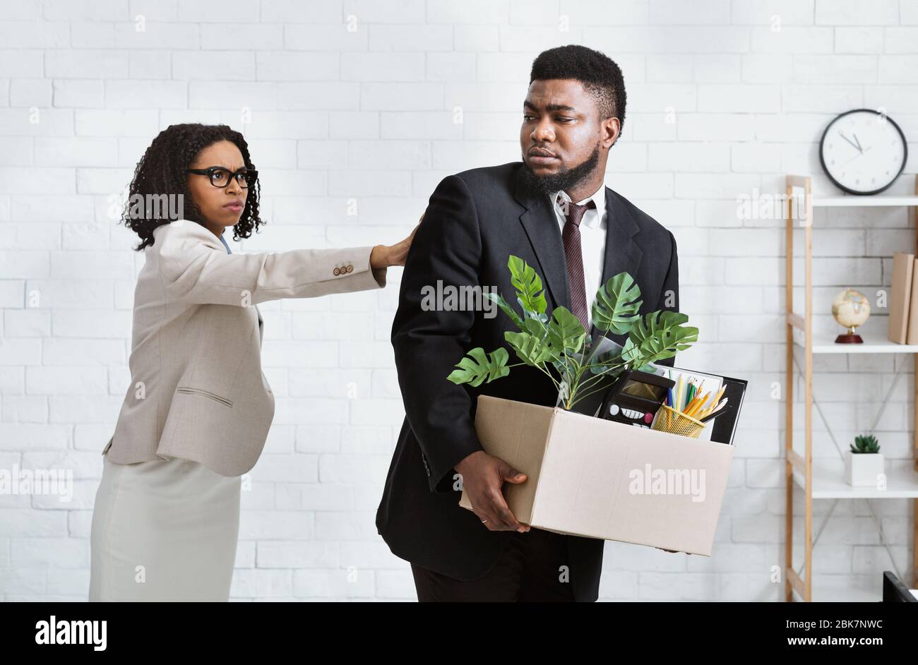 Job loss and unemployment. Female boss firing African American employee in office Stock Photo