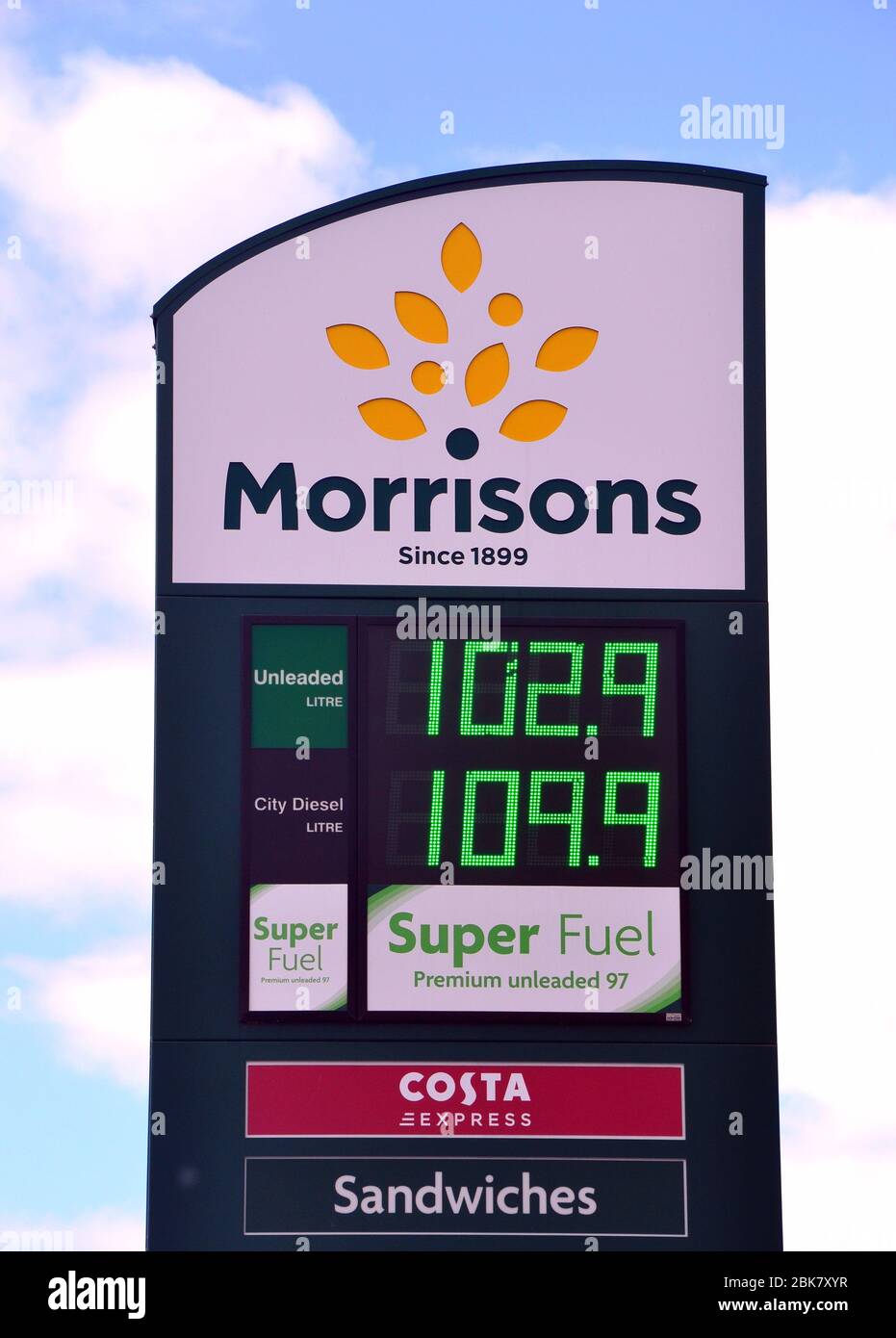 Morrisons petrol station price sign in Manchester, England, United Kingdom, showing unleaded at 102.9 pence a litre. Oil prices fell in Spring 2020. Stock Photo