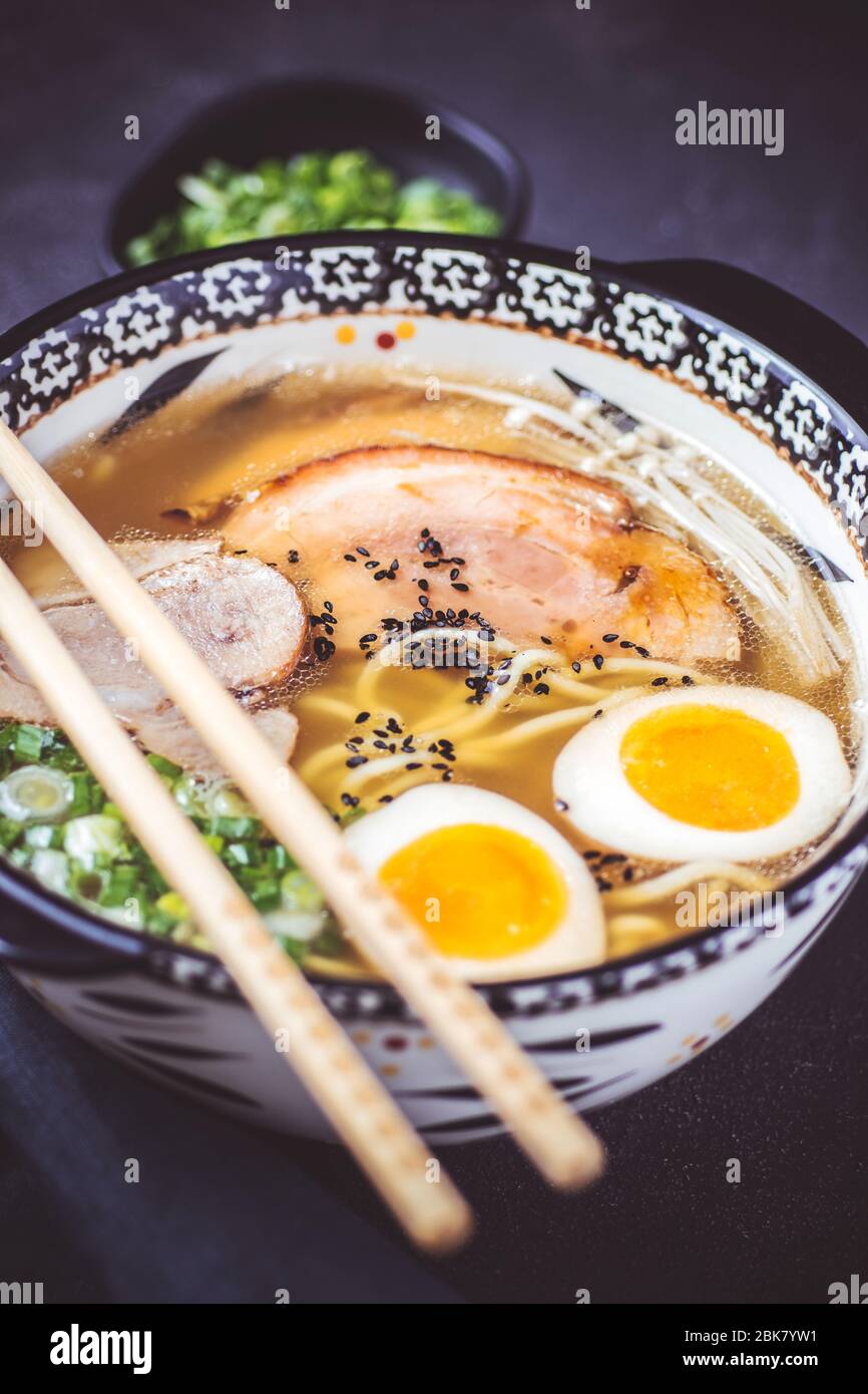 Rich Traditional Japanese Ramen Soup with Homemade Udon Noodles, Pork and Eggs Stock Photo