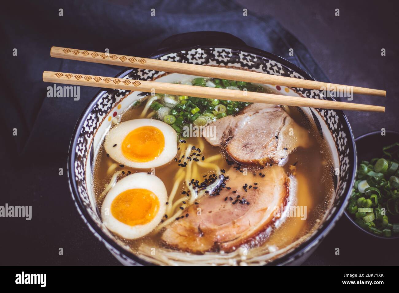 Rich Traditional Japanese Ramen Soup with Homemade Udon Noodles, Pork and Eggs Stock Photo