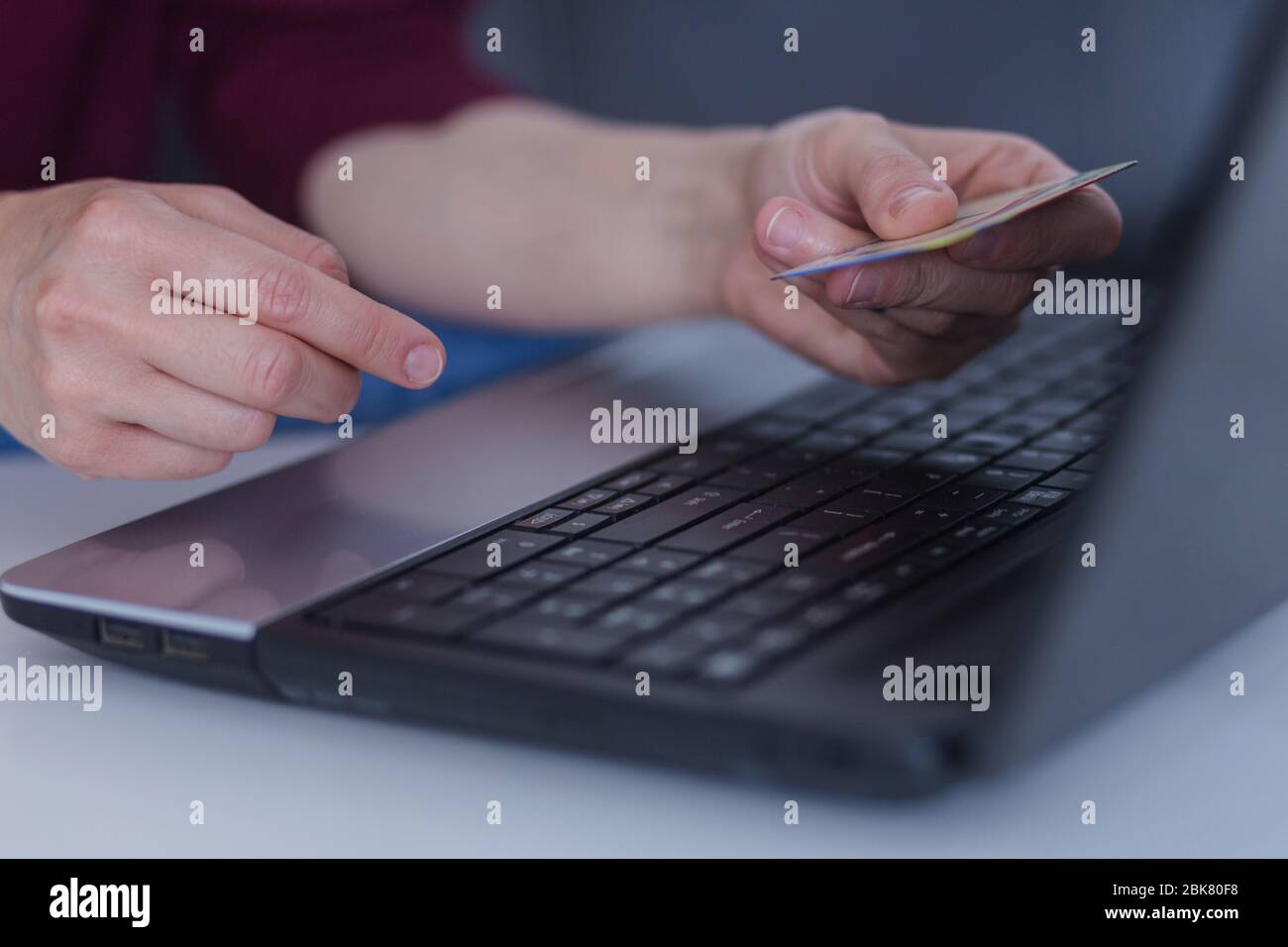 Hands holding credit card and using laptop. Online shopping Stock Photo