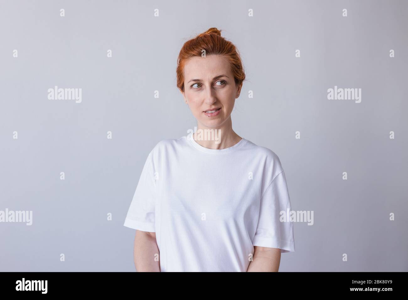 Headshot Portrait of happy ginger girl with freckles smiling . White background. Stock Photo