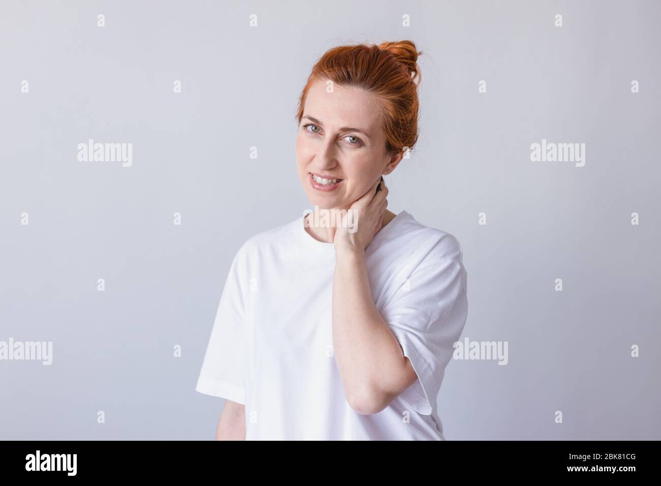 Portrait of young beautiful cute cheerful girl smiling looking at camera over white background. Stock Photo