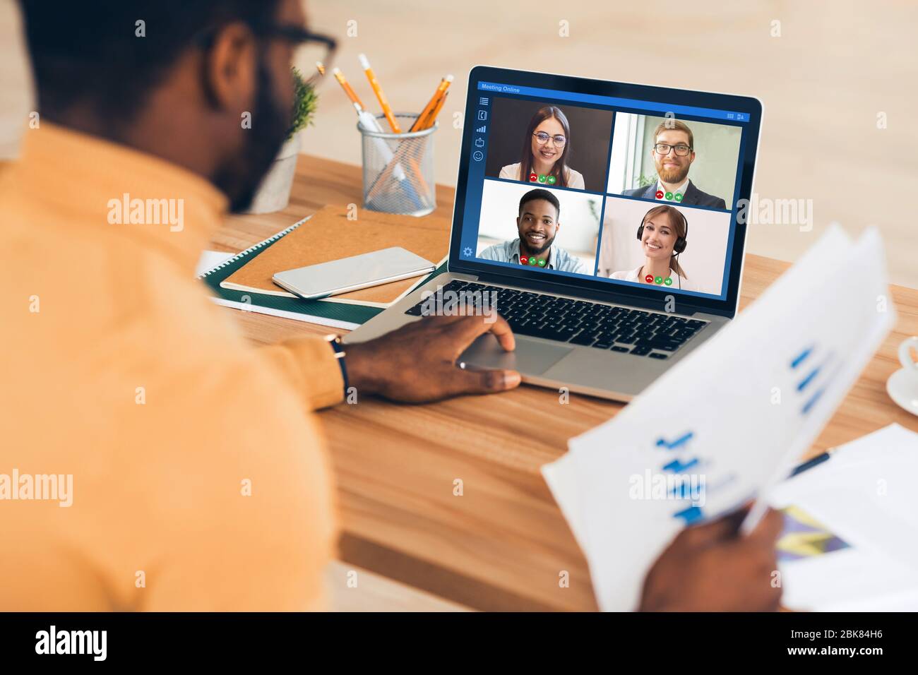 African American employee having online business conference with colleagues at home office, collage Stock Photo