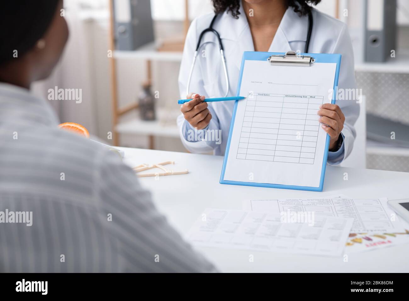 Dietician showing female patient treatment plan, cropped Stock Photo