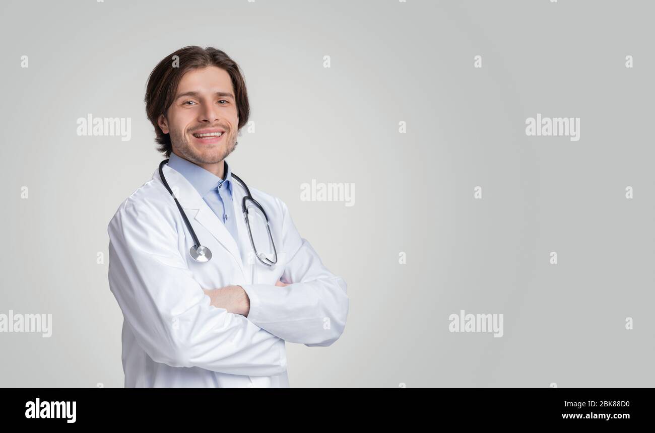 Portrait Of Smiling Medical Adviser Wearing White Coat And Stethoscope Stock Photo