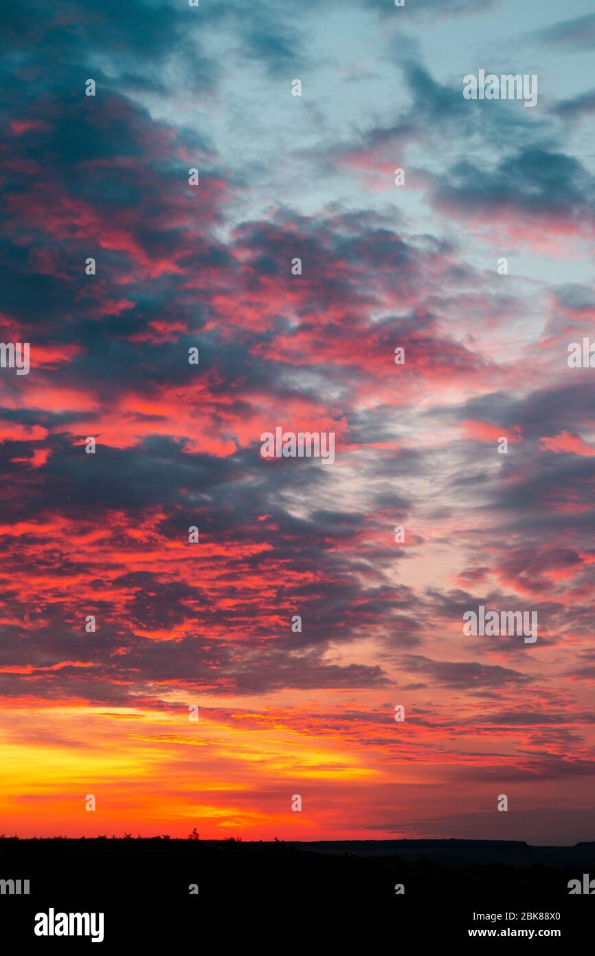 Beautiful fiery orange sunset sky with horizon Stock Photo