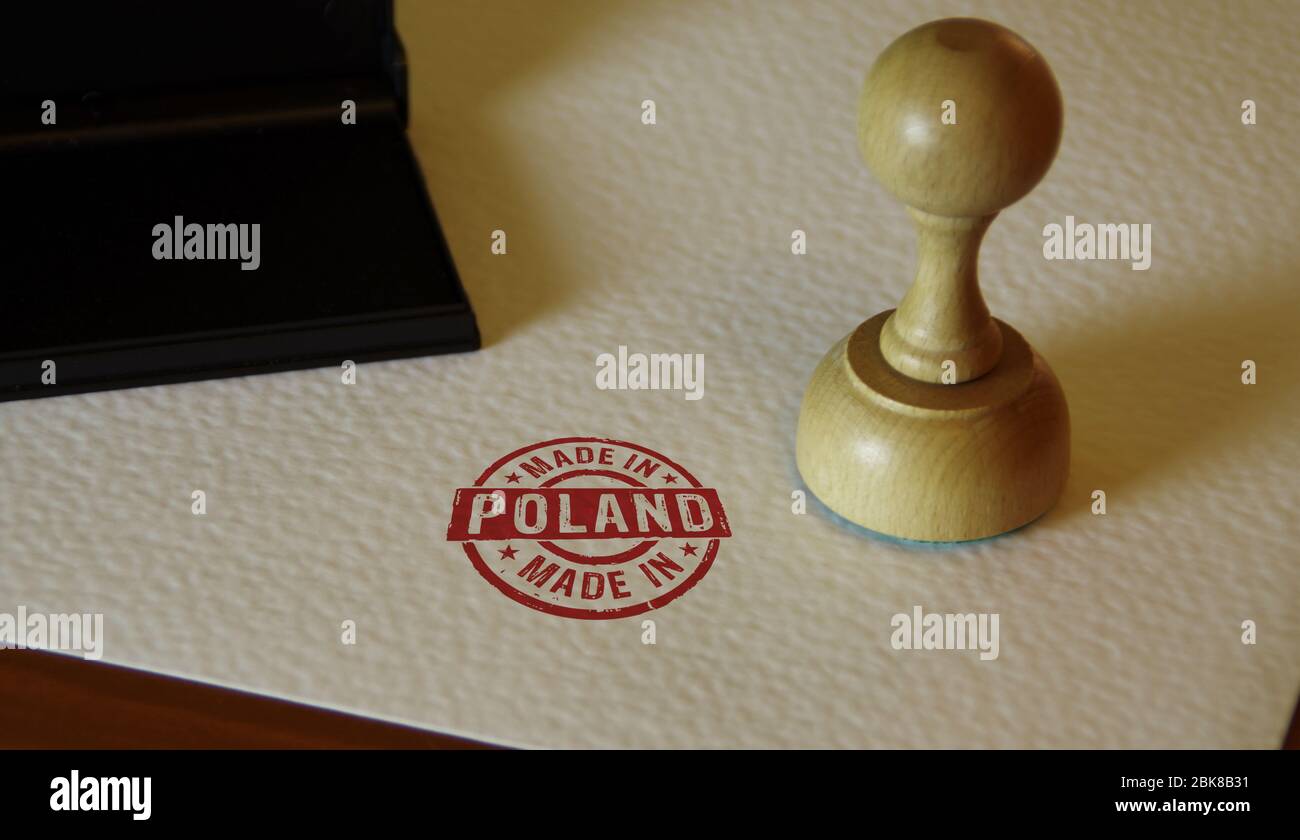 Made in Poland stamp and stamping hand. Factory, manufacturing and production country concept. Stock Photo