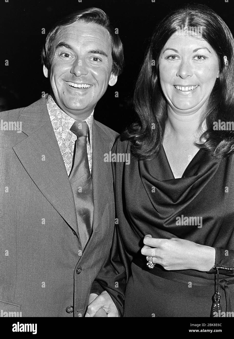 LONDON, UK. October 1974: Comedian Bob Monkhouse & wife at the premiere of 'That's Entertainment' in London.  File photo © Paul Smith/Featureflash Stock Photo