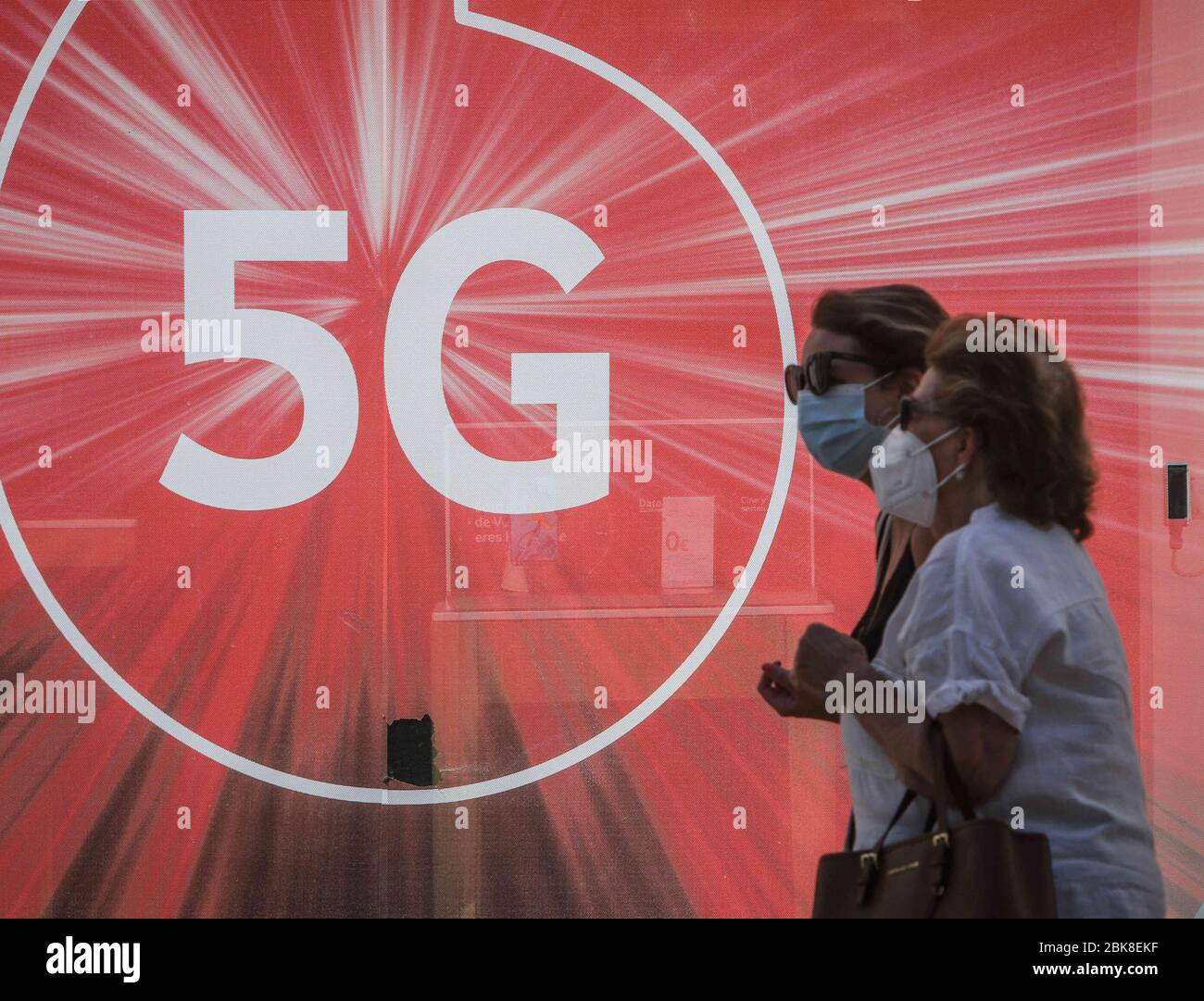 May 2, 2020: May 2, 2020 (Malaga) people walk with mask in front of a 5 G mobile poster Credit: Lorenzo Carnero/ZUMA Wire/Alamy Live News Stock Photo