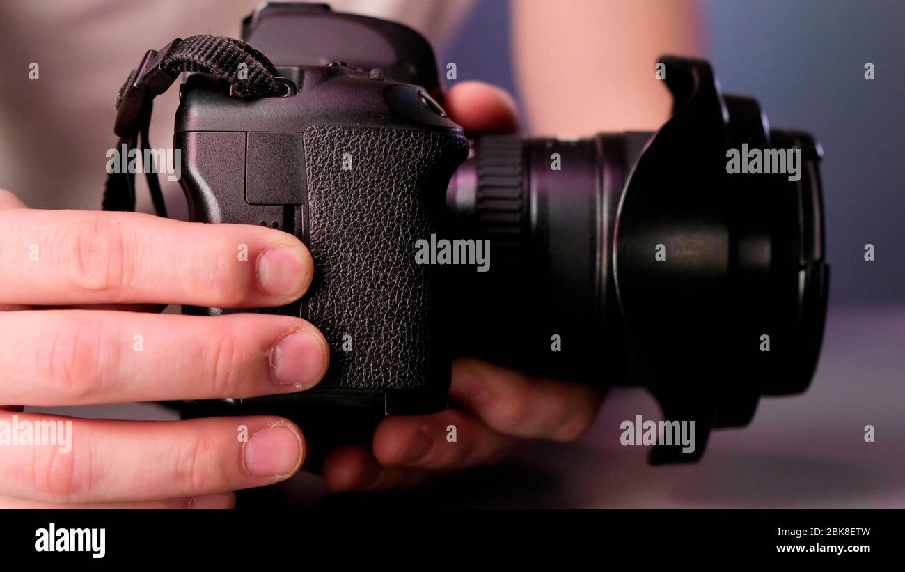 Hand removing memory card from slot of camera Stock Photo