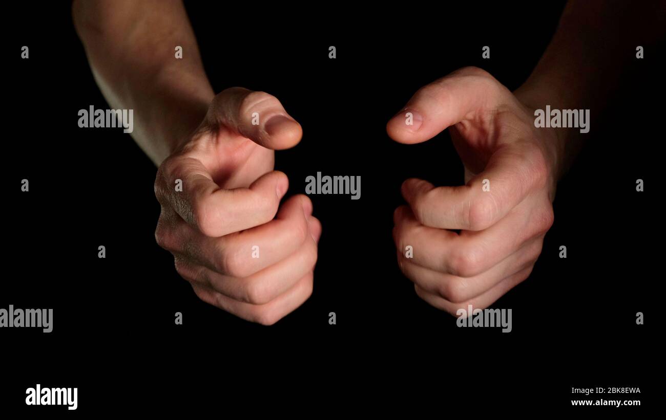 Human male palm clench a fist isolated on black background. Close up. Stock Photo