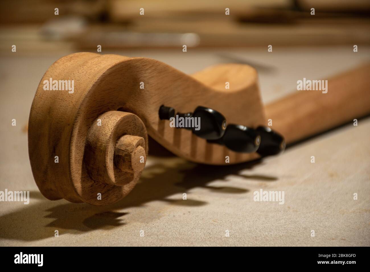 handmade wooden stringed instrument part, a custom cello headstock & snail with ebony wood