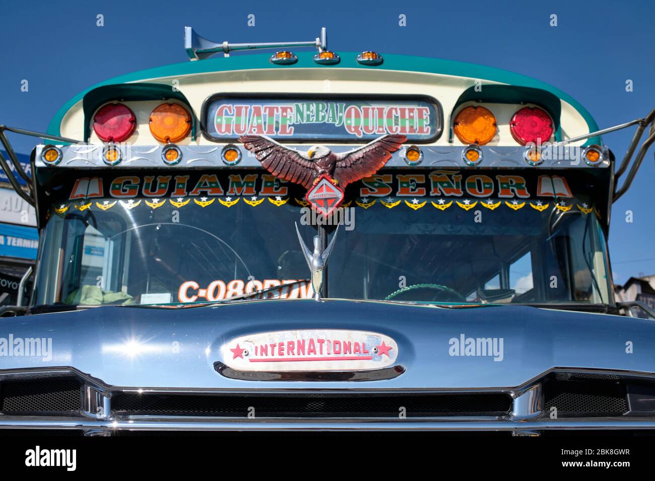 Old, well-kept bus, painted in colors and decorated, parked at the Chichicastenango station. Stock Photo