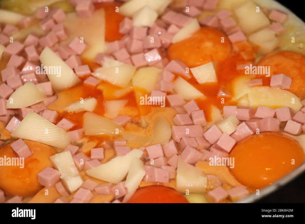Fried eggs with ham and cheese. Delicious english breakfast. Stock Photo